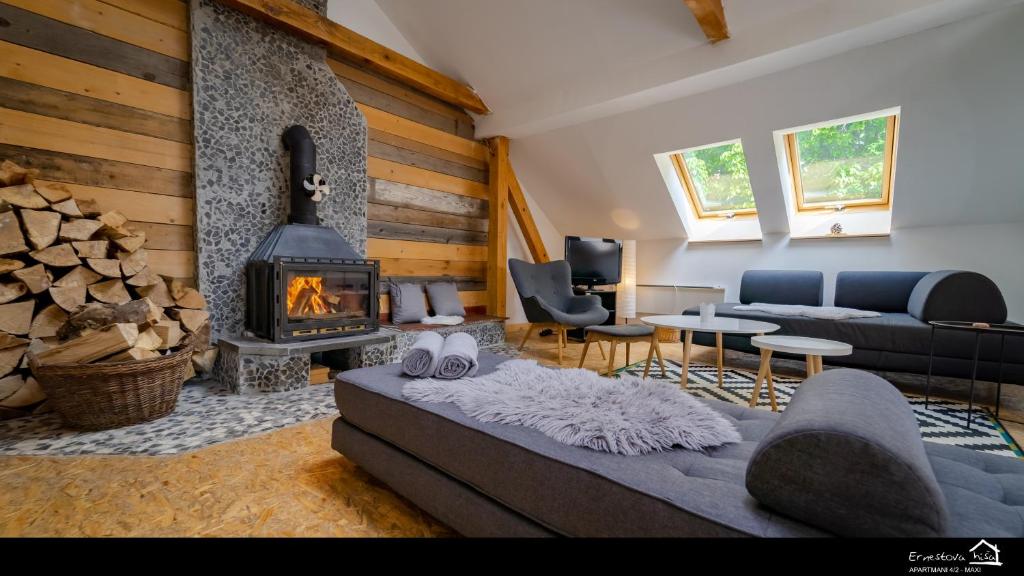 a living room with a couch and a fireplace at Apartment Ernestova hiša in Lokve