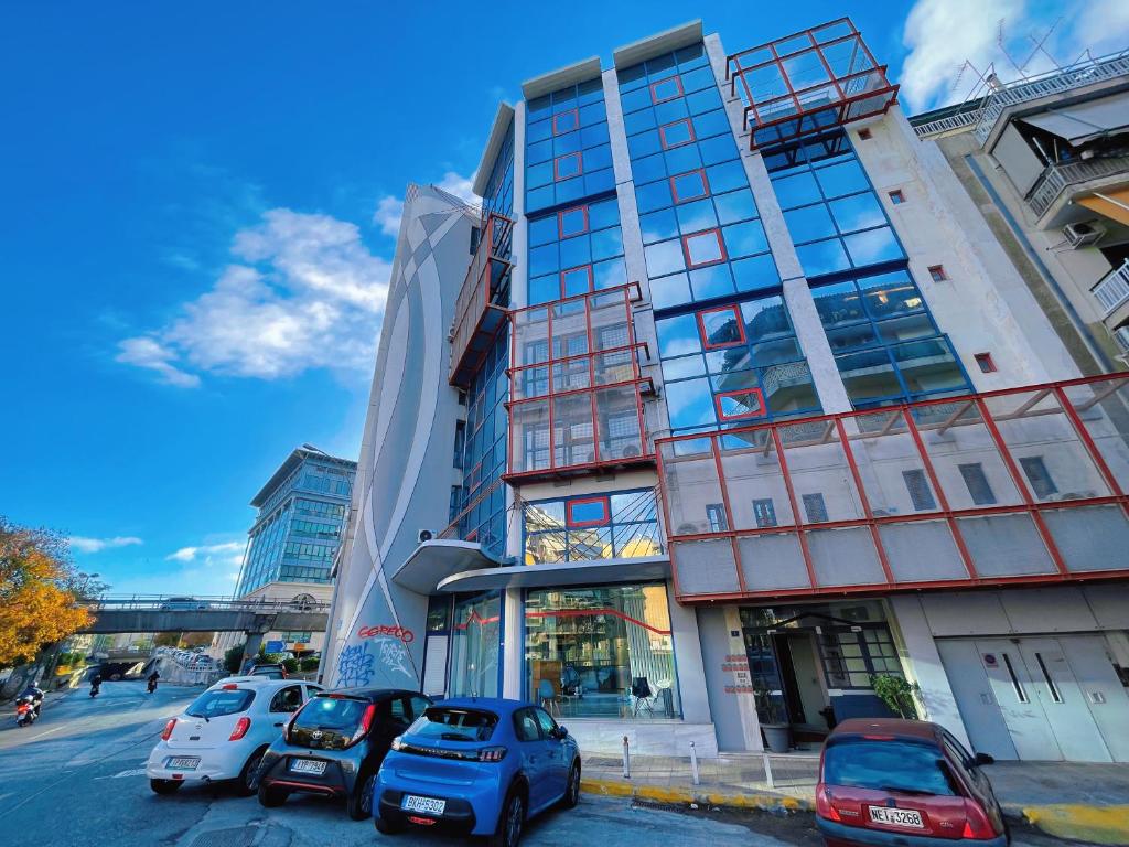 a building with cars parked in front of it at WSD Baia Acropolis Hotel Apartment in Athens