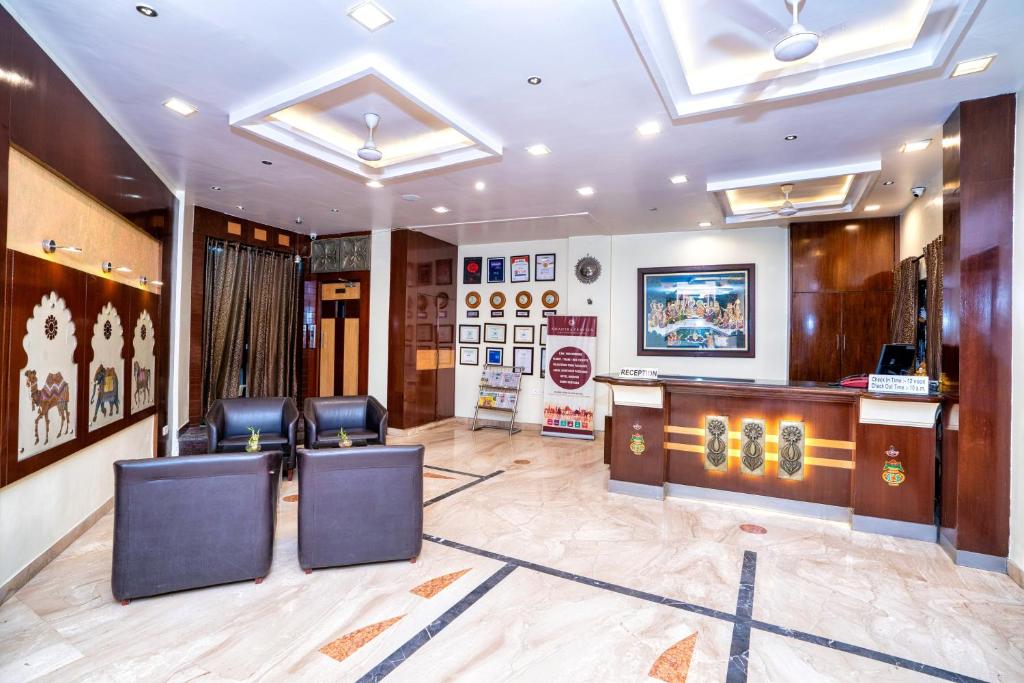 a waiting room with leather chairs and a desk at Hotel Dayal in Udaipur