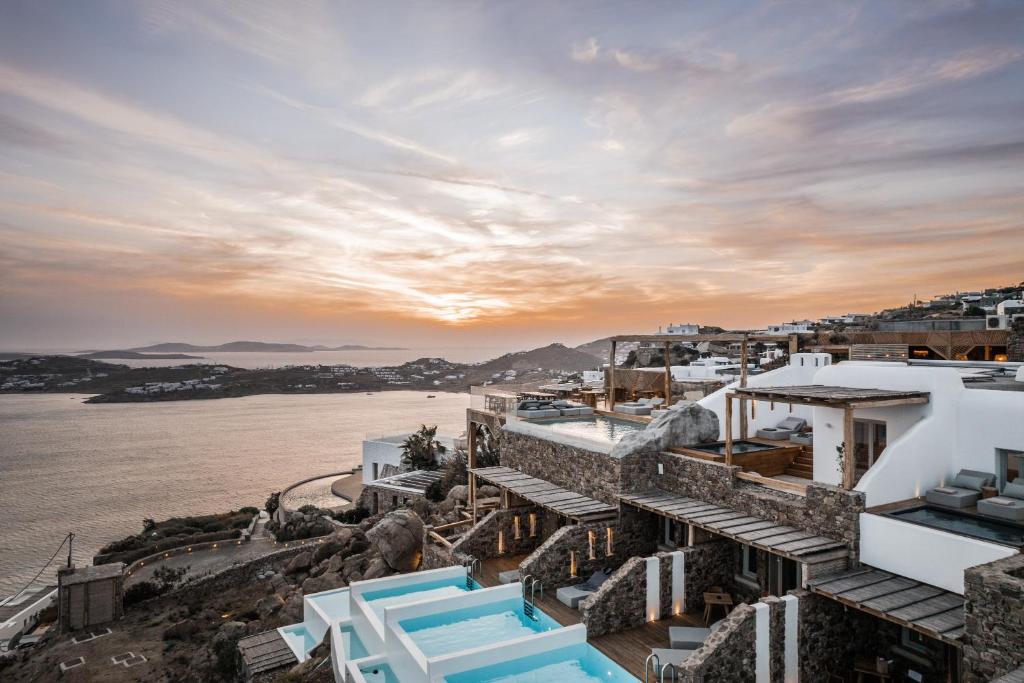 a view of the ocean from a resort with white buildings at Alissachni Mykonos in Psarou