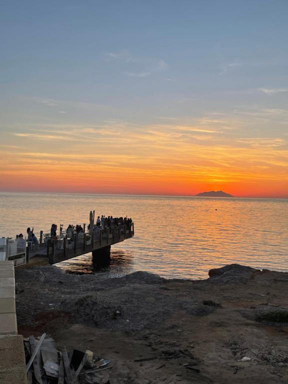 a group of people standing on a pier over the water at Marsala al centro n 9 in Marsala