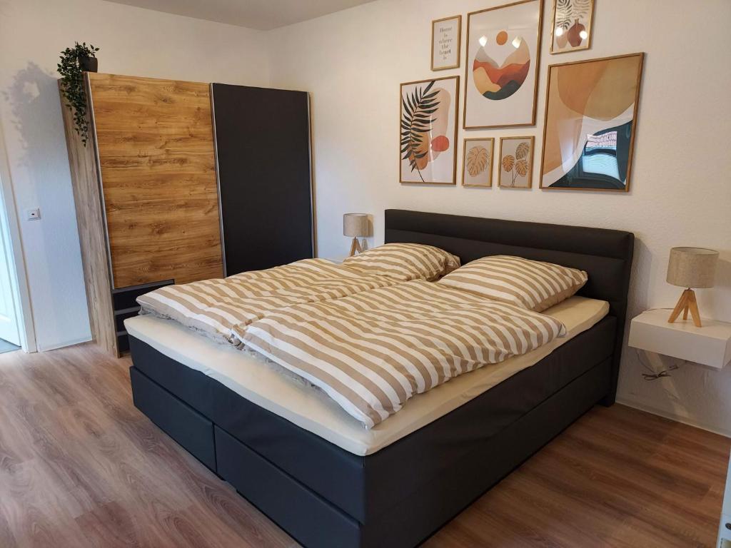 a bedroom with a bed with a striped blanket on it at Apartment 1 Unter den Eichen 