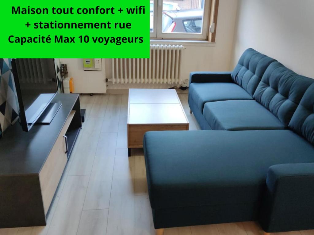 a living room with a blue couch and a table at La cosy house Tourcoing in Tourcoing