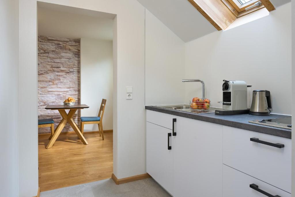 a kitchen with a counter and a table in a room at Thermen Appartements Gabriela, 38 qm in Bad Krozingen