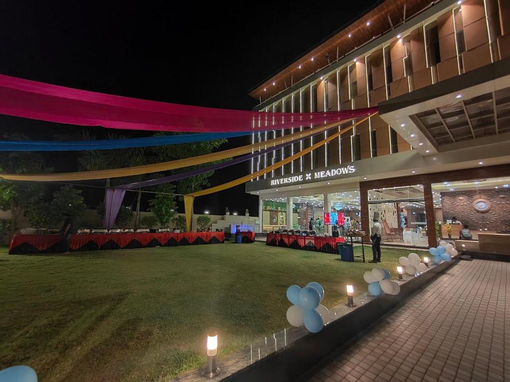 a building with a lawn with candles in front of it at RIVERSIDE MEADOWS in Vidisha