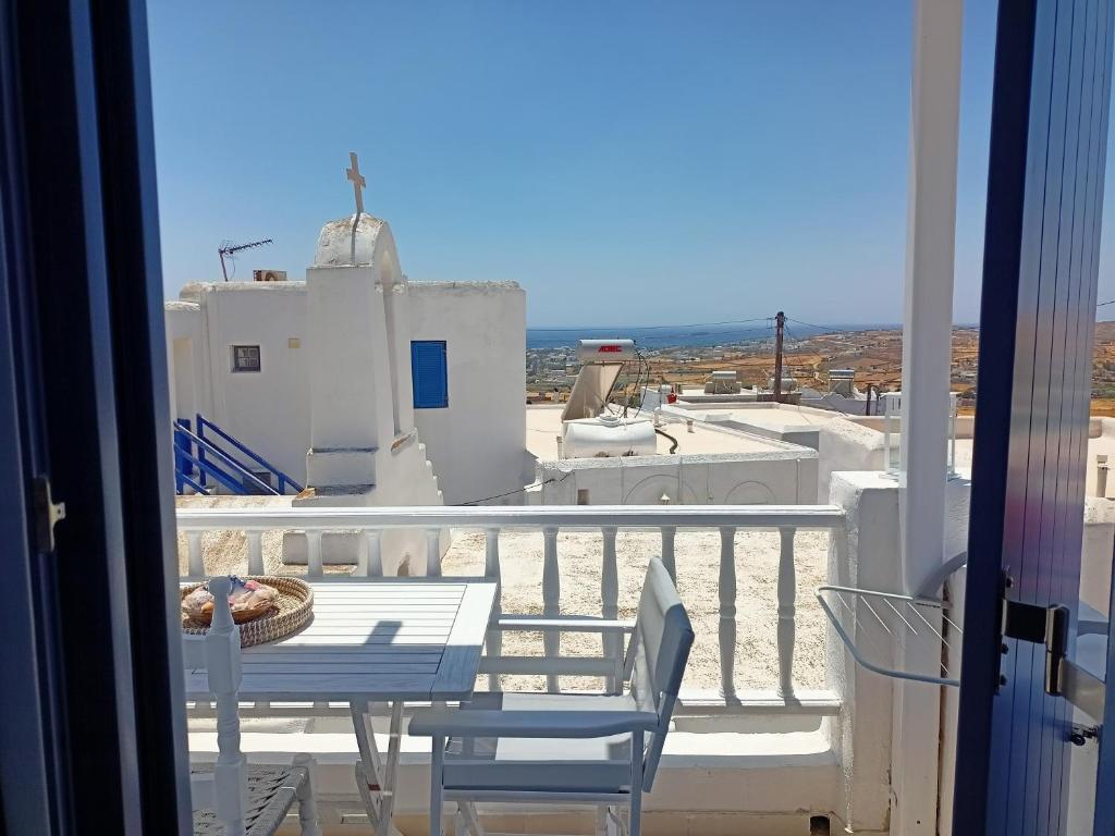 a view of a balcony with a table and chairs at Amphitrite's Haven - Cycladic House in Marpissa, Paros in Márpissa