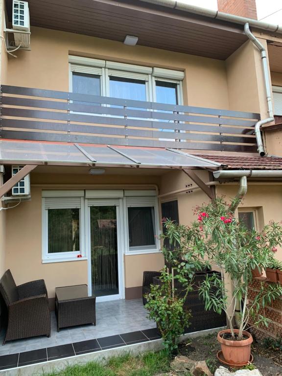 a house with a patio with a metal railing at Malom Vendégház in Szarvas