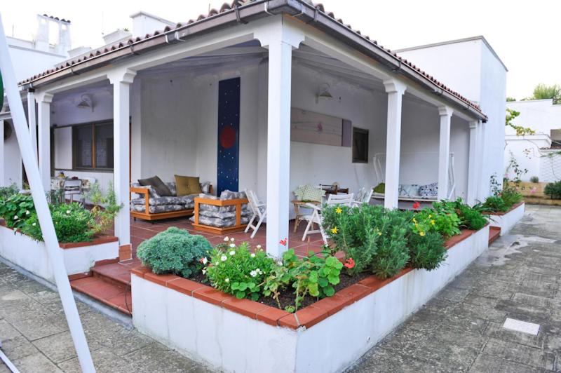 Una casa con un porche con plantas. en Santos B&B, en Bari