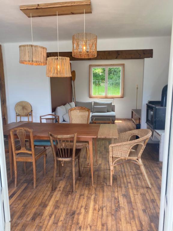 a dining room and living room with a table and chairs at MAISON STERNA : maison familiale en bord de mer in Kerouguel