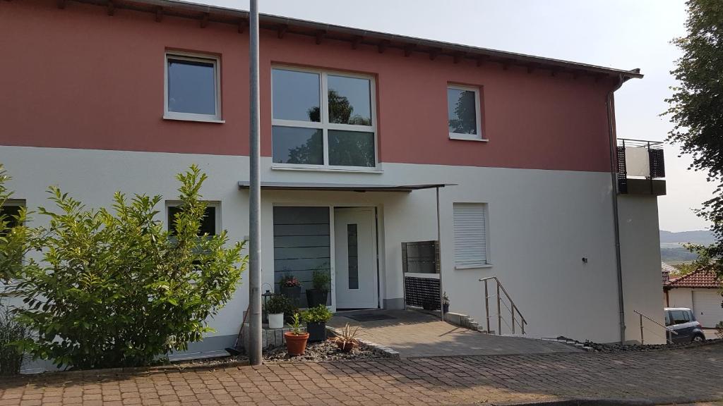 a house with a red and white at Ferienwohnung Chattengau in Niedenstein