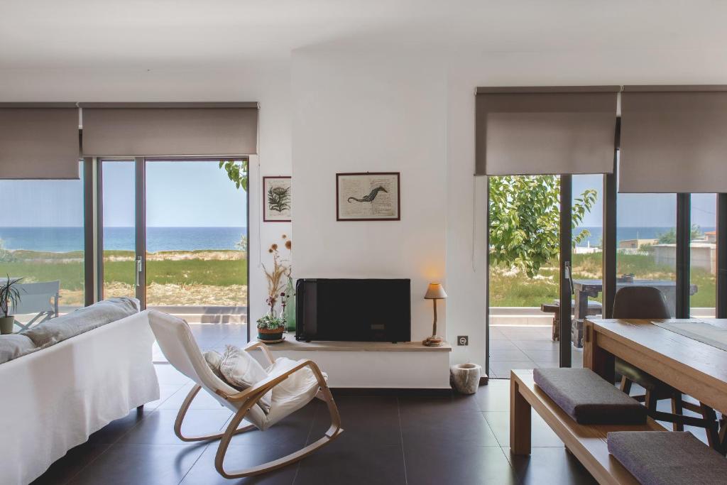 a living room with a view of the ocean at Seafront Villa Blue Agave in Magnisía