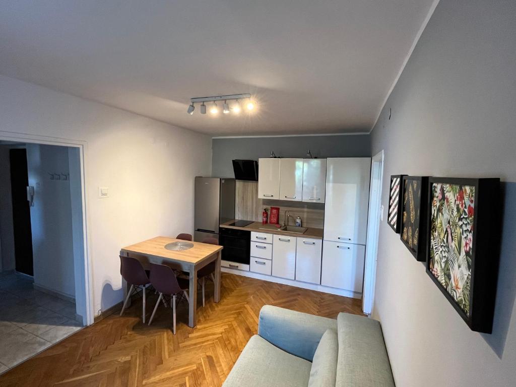 a living room with a couch and a table at City Apartments - Emilii Budget Stay in Zgorzelec