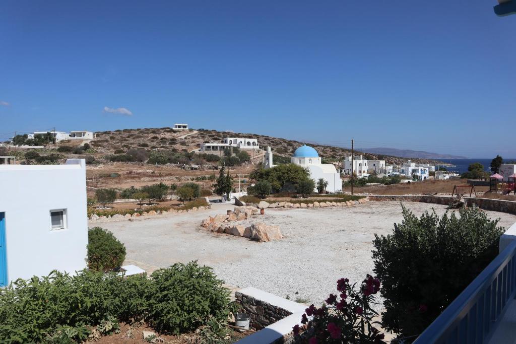 arial view of a large yard with a church and buildings at Taxiarchis Studios in Áyios Yeóryios