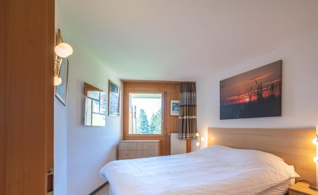 Postel nebo postele na pokoji v ubytování Eden Resort Anzère