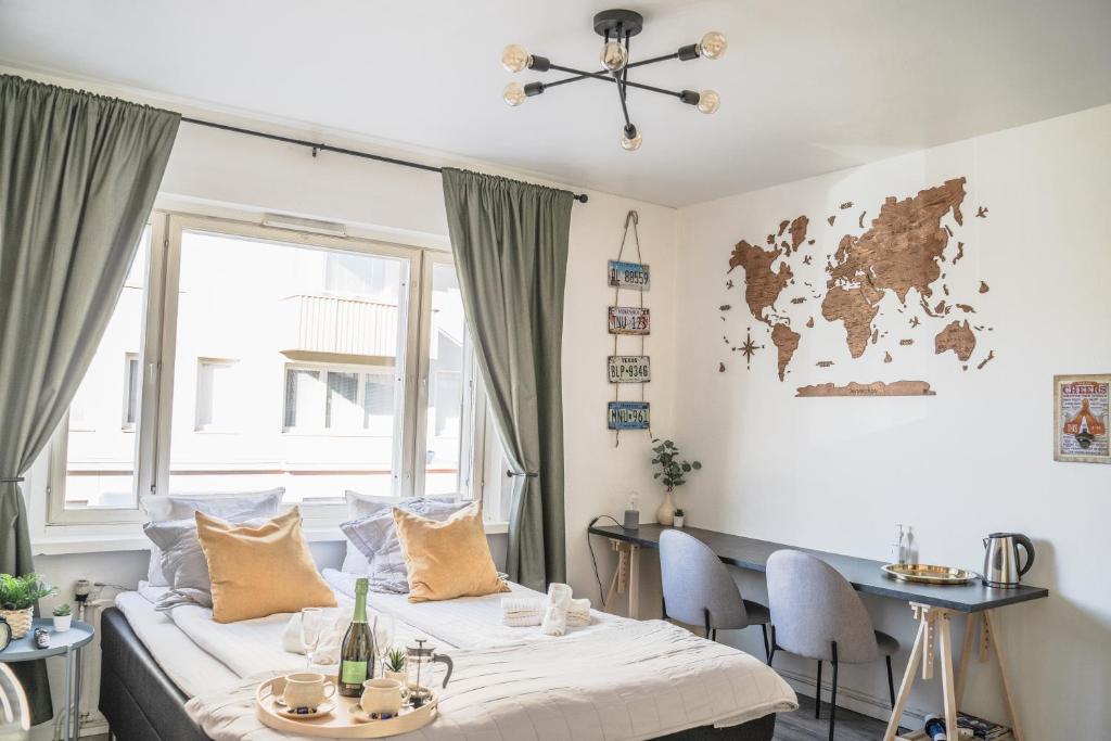 a room with a bed and a table with chairs at Studio apartment in the heart of Jakobstad in Pietarsaari