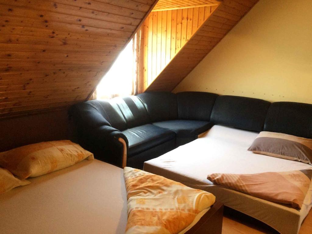 a living room with a couch and a couch at Apartment Orvenyes 1 in Örvényes