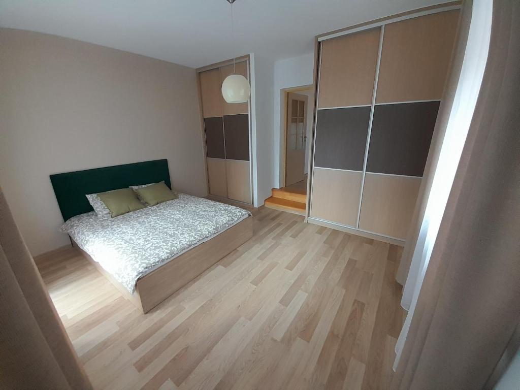 a bedroom with a bed and a large closet at Apartament Koninki in Koninki