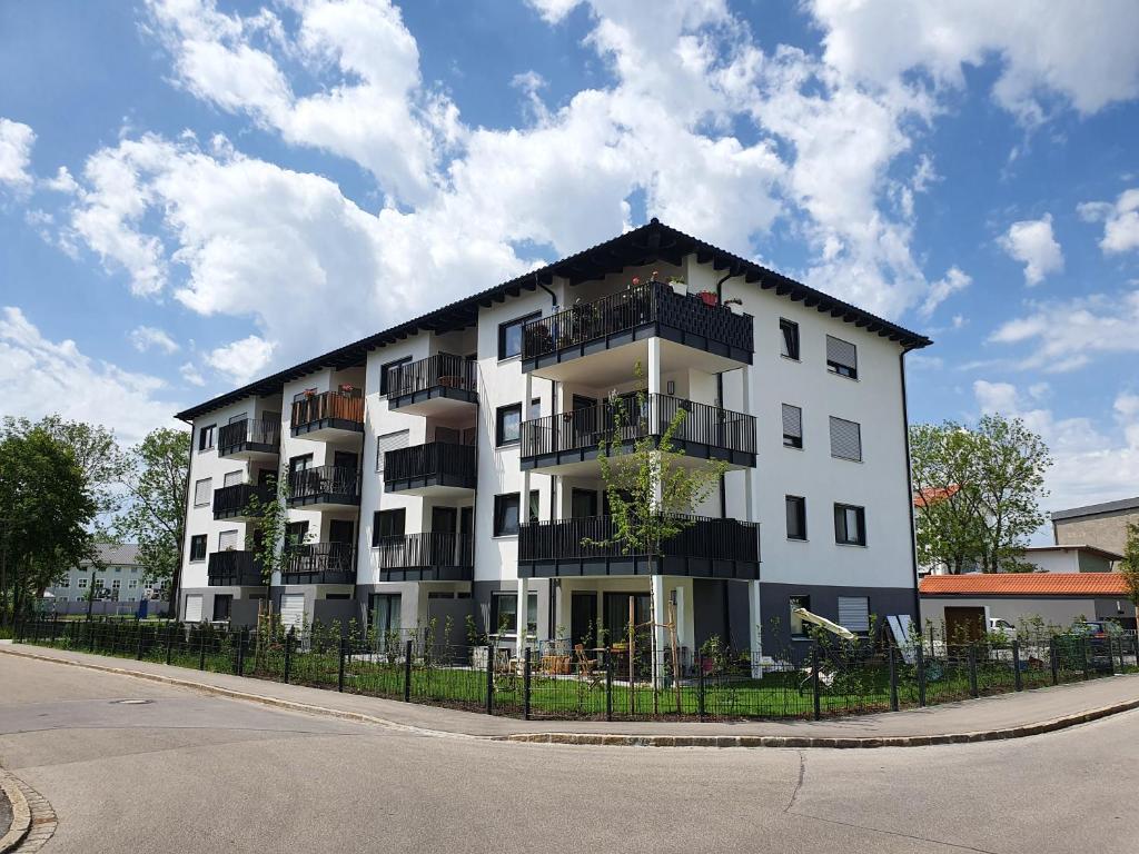 a white apartment building with a black roof at Traumwohnung Füssen 14 in Füssen