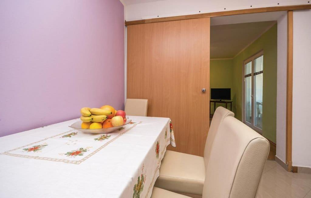 a bowl of fruit on a table in a room at Apartmani Andrija in Pakoštane