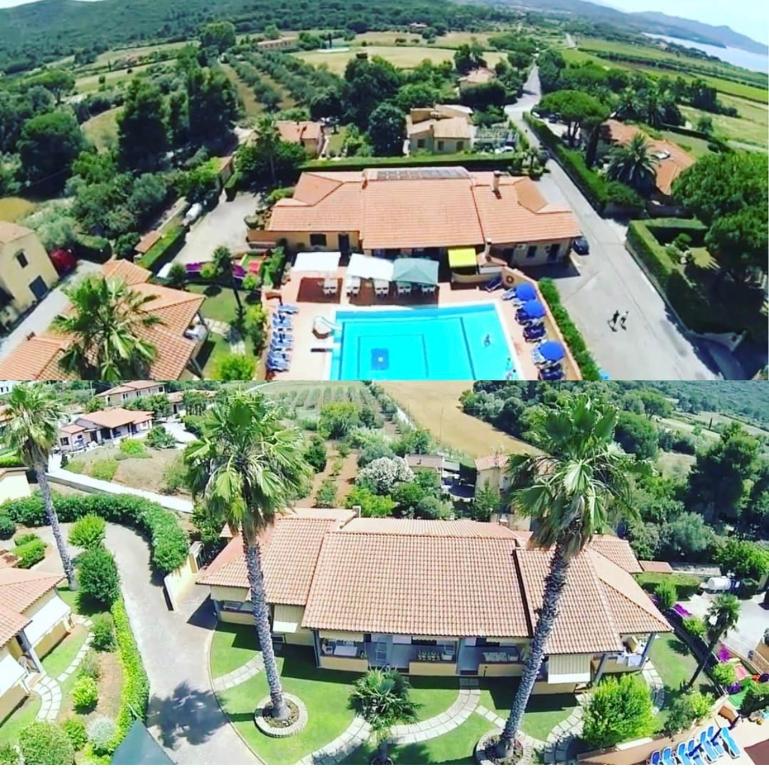 an aerial view of a resort with a pool and palm trees at Residence Alithai in Portoferraio