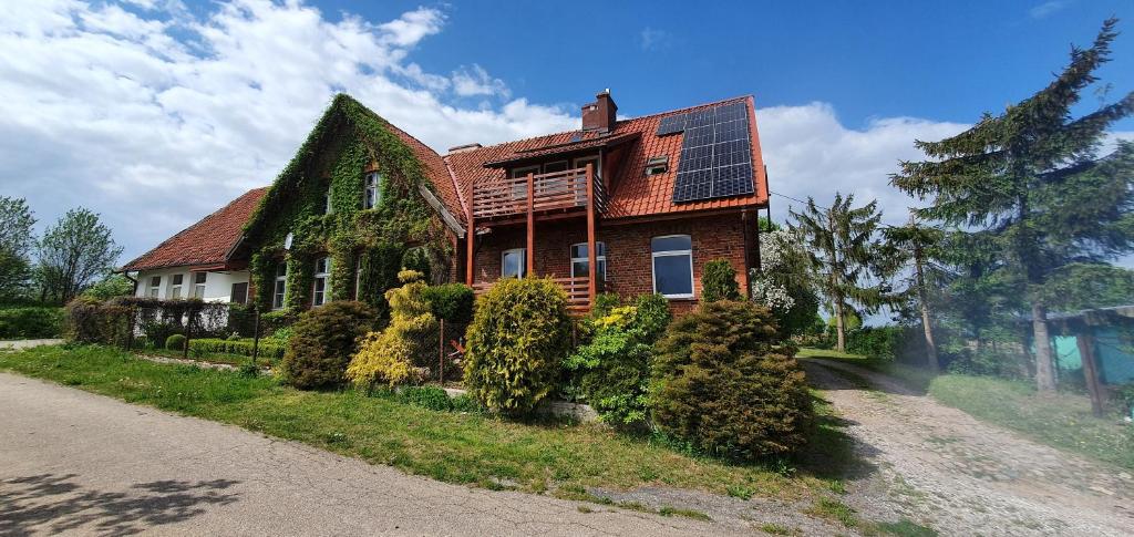 a house with a solar panel on top of it at Mazurska przystań in Dąbrówno