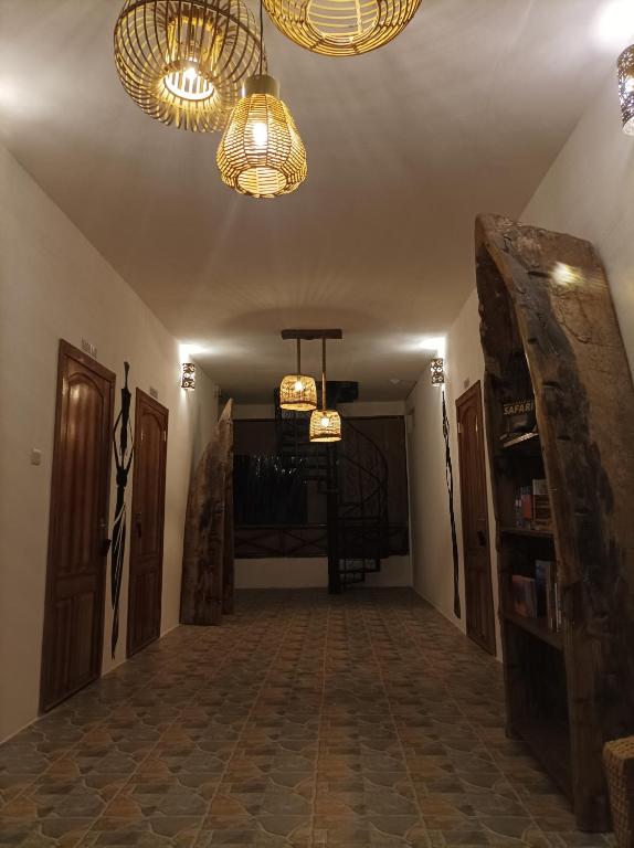 a hallway with two chandeliers and a hallway with a room with a hallway at Zanzicrown in Nungwi