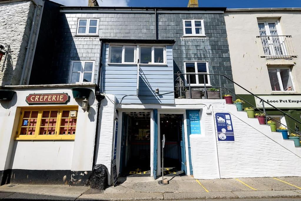a building with the door open on a street at Beautiful 3 bedroom cottage in the heart of Looe in Looe