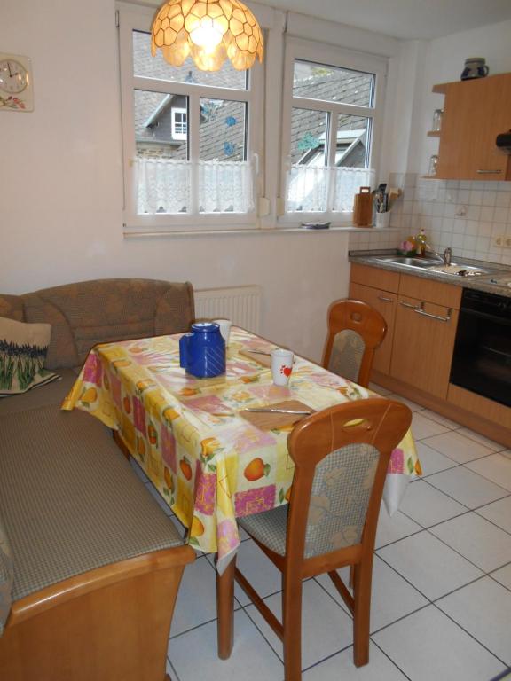 a kitchen with a table with a table cloth on it at Wohnung Feuerberg mit Südbalkon in Ediger-Eller