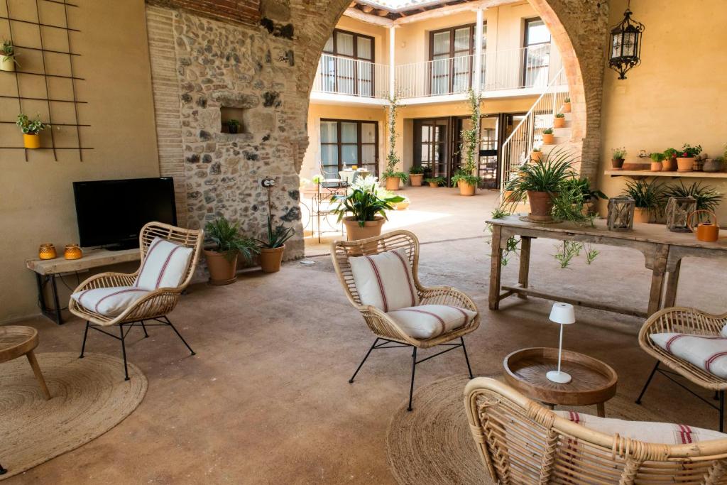 a large room with chairs and a table and a tv at Mas Pla in Riudellots de la Selva