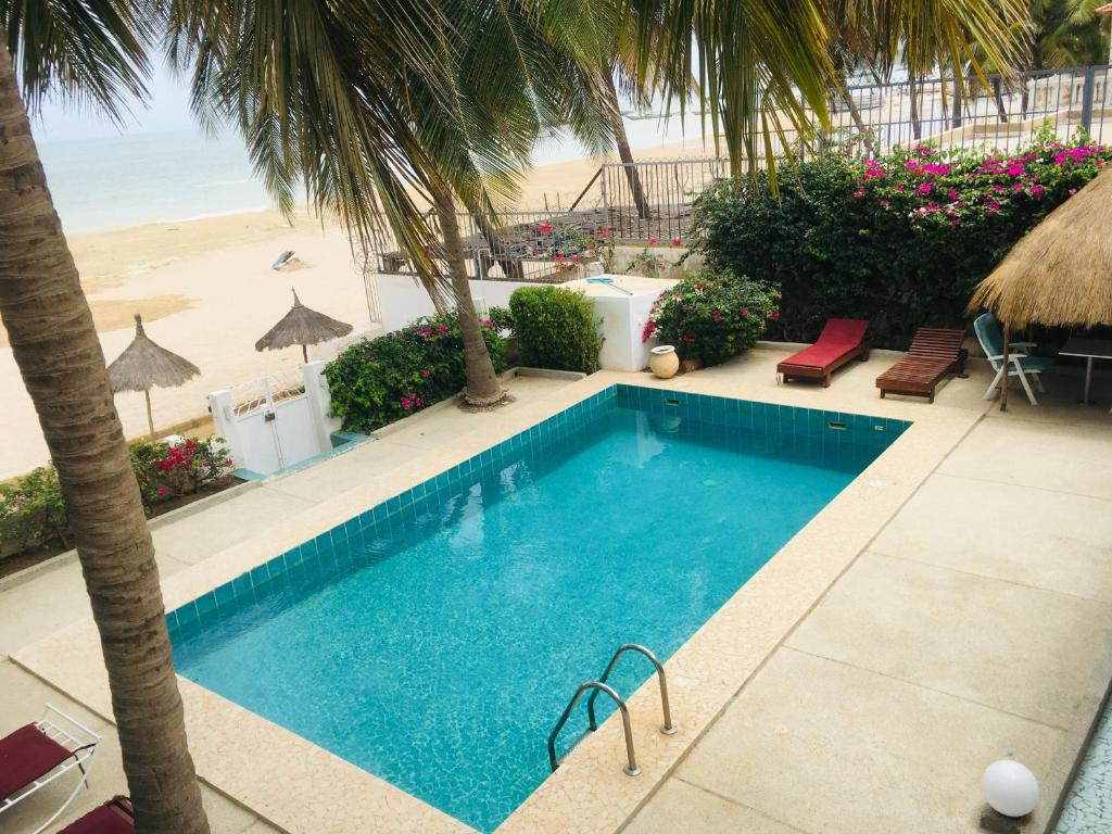 a swimming pool with a view of the beach at West AFRICAN BEACH in Sali Nianiaral