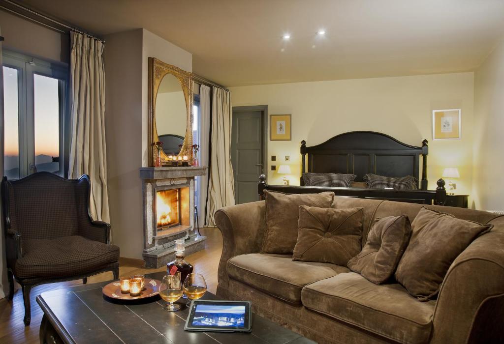 a living room with a couch and a bed at Aegli Arachova in Arachova