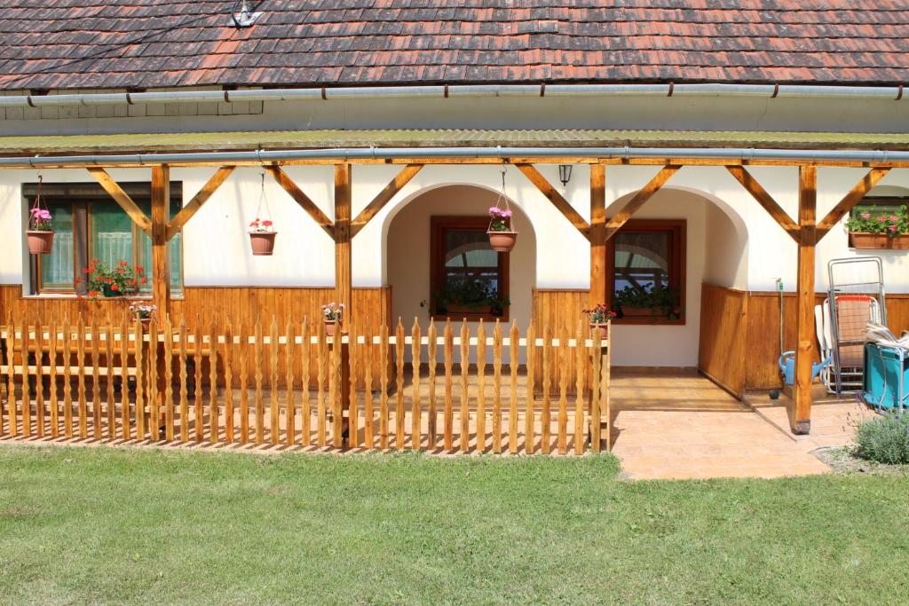 uma cerca de madeira em frente a uma casa em Orbán Porta em Szalafő