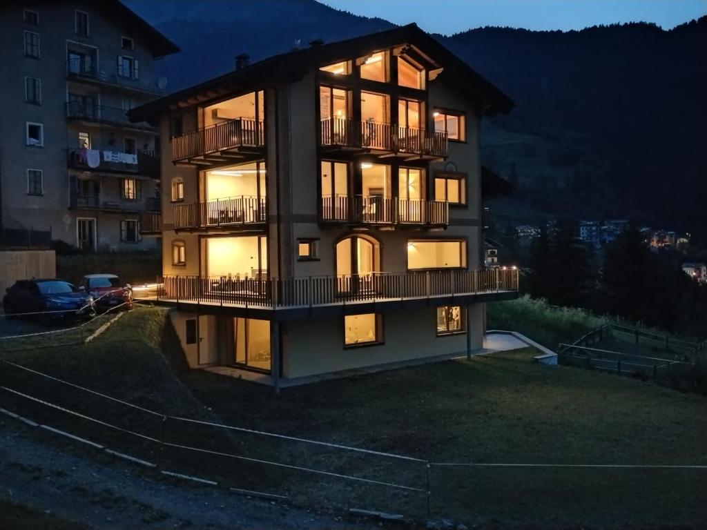 a large building with lights on at night at Chalet MAOL Luxury Living in Valdidentro