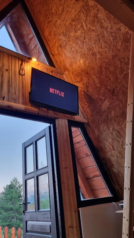 a sign that reads netflix on the side of a building at A Pine vikendica u srcu Zapadne Srbije in Nova Varoš