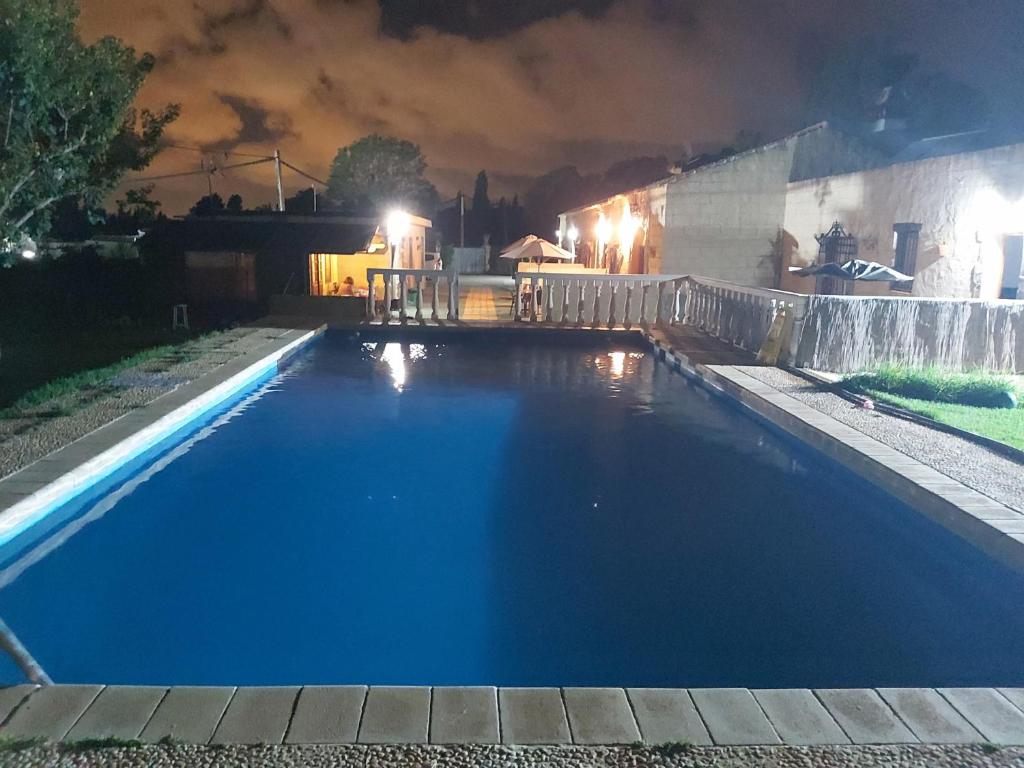 a swimming pool in a backyard at night at Los Duendes in El Puerto de Santa María