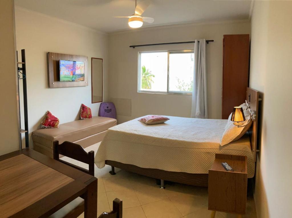 1 dormitorio con 2 camas y ventana en Joneson aluga QUITINETE próximo a Praia do Forte até 4 pessoas, en Cabo Frío