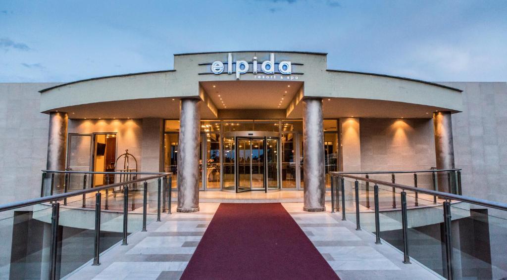 a store front of a building with a red walkway at Elpida Resort & Spa in Serres