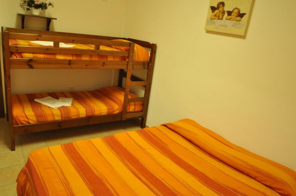 Postel nebo postele na pokoji v ubytování Ostello Del Volo