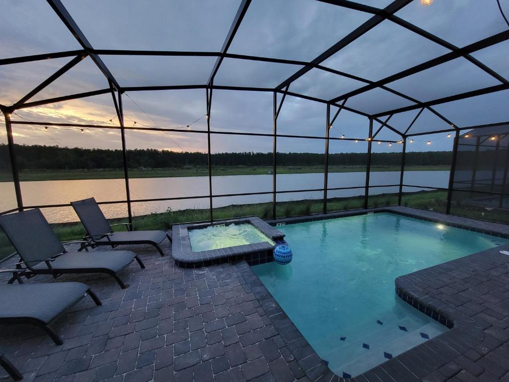 a swimming pool in a tent with a view of a river at Winterfield Storey Lakeview 4173 in Kissimmee