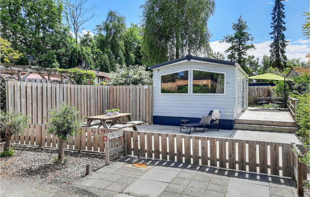 a backyard with a fence and a shed at 2 Bedroom Nice Home In Heinkenszand in Heinkensand