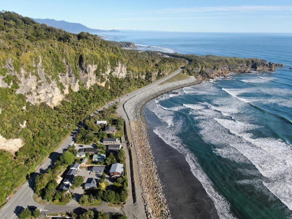 an aerial view of a beach and the ocean at Punakaiki Beachfront Motels in Punakaiki
