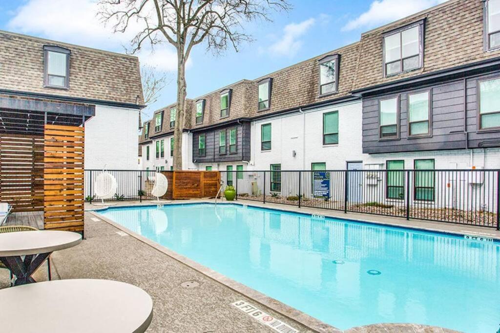 a swimming pool in front of a building at Lovely 2 Bedroom + Den Apartment at Medical Center - Sleeps 8 in Houston