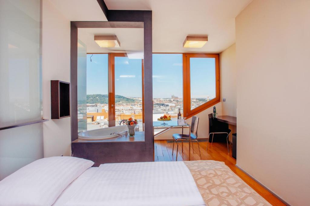a bedroom with a bed and a view of a bathroom at Wenceslas Square Hotel - Czech Leading Hotels in Prague