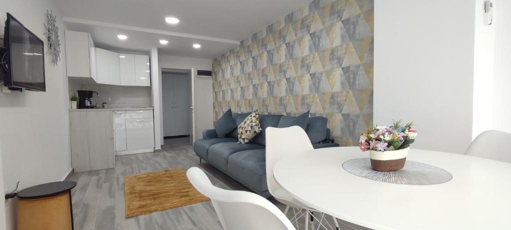 a living room with a white table and a couch at Olimp Family - Olimp Sea View Apartments in Olimp