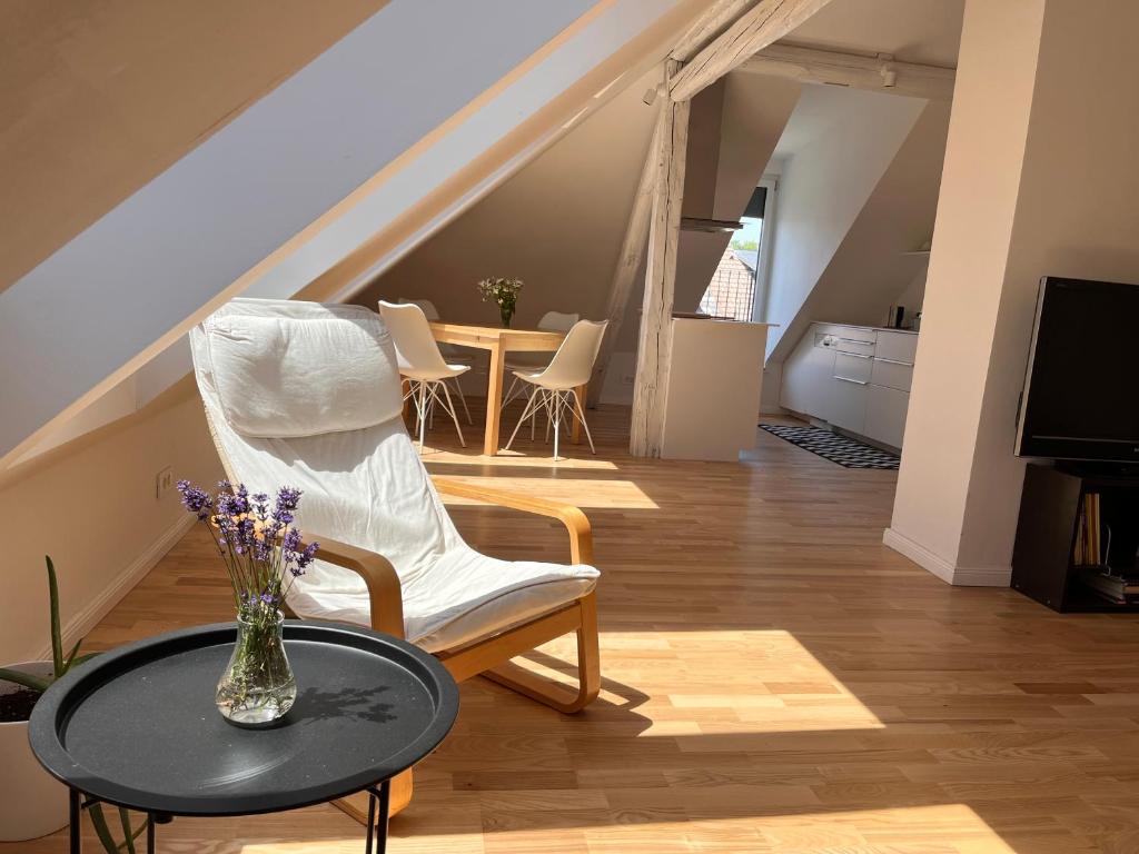 a living room with a chair and a table at Apartment Malina - free private parking in Ljubljana