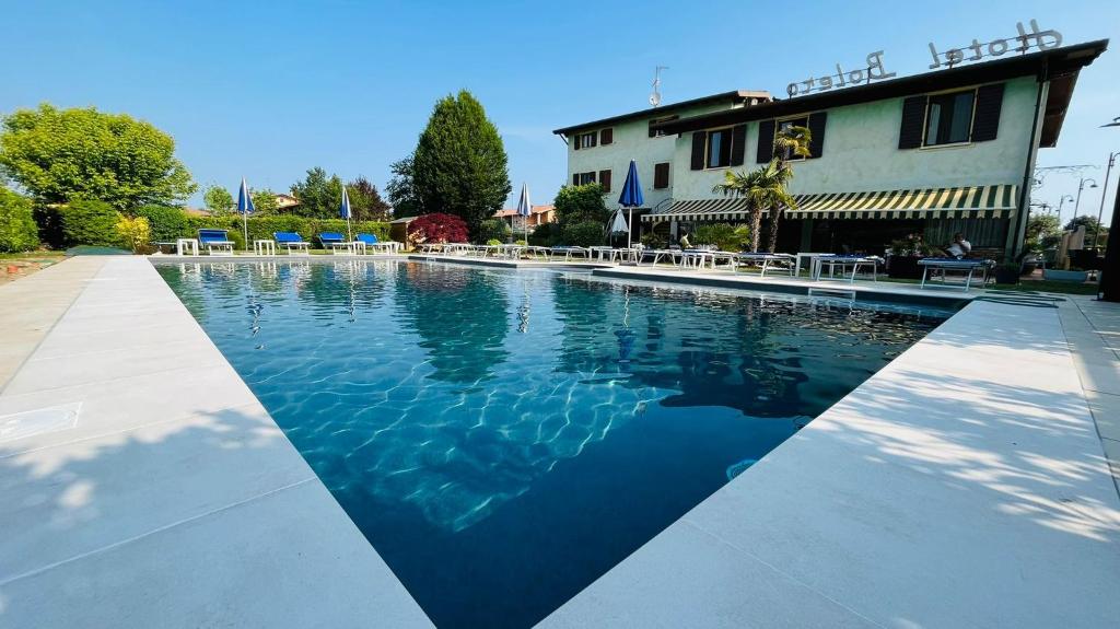 a swimming pool in front of a building at Hotel Bolero in Sirmione