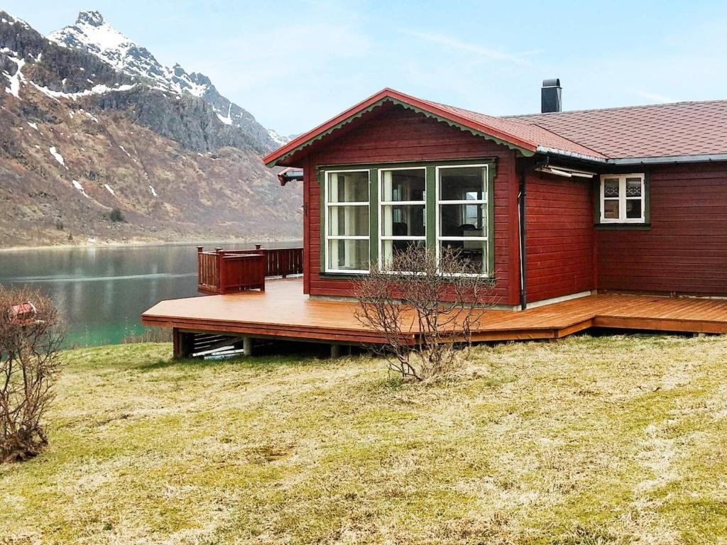 a house with a deck next to a lake at 6 person holiday home in Tengelfjord in Tengelfjorden