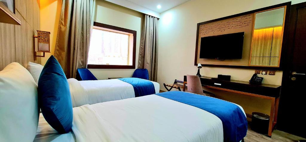 Postel nebo postele na pokoji v ubytování Al Ebaa Hotel