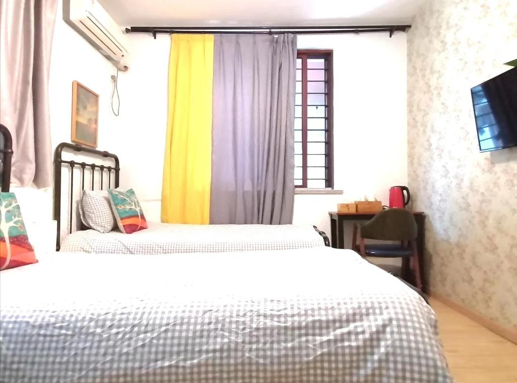 Postel nebo postele na pokoji v ubytování Hangzhou Citynest Music B&B