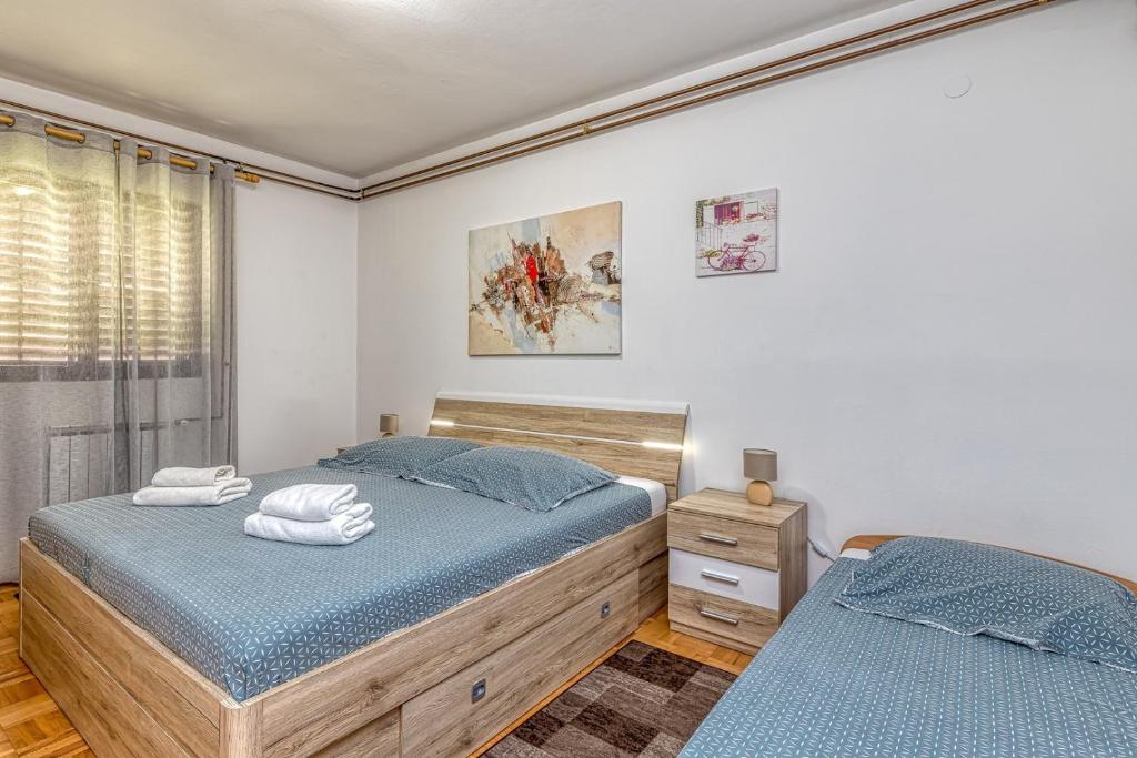 a bedroom with two beds and a window at Emanuela with Private Pool in Loborika